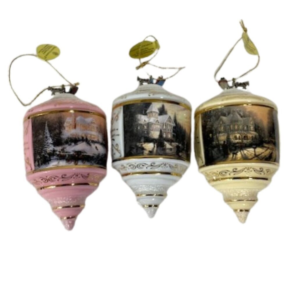 Three Vintage Thomas Kinkade ornaments.
